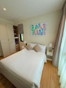 a bedroom with a large white bed with white sheets at FAMILY HOMES HALO, brand new 2-bedroom Apartment with Pool Access in Phuket