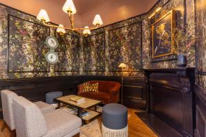 a living room with a couch and a table at Blackbird Hotel in New Orleans
