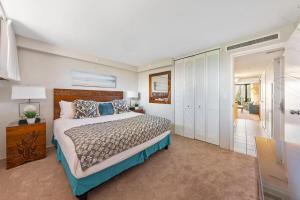 a bedroom with a large bed and a sliding glass door at Kaanapali Shores 548 in Kahana +65 photos