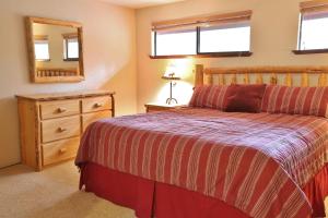 a bedroom with a bed and a dresser and a mirror at 8 Leisure in Sunriver