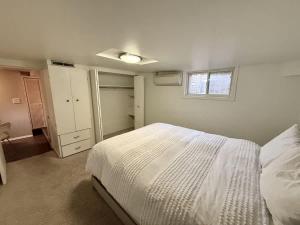 a bedroom with a white bed and a window at Charming Marmalade Flat in Downtown Salt Lake City in Salt Lake City