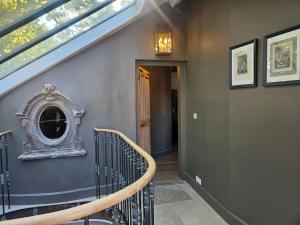a staircase in a house with a mirror on the wall at La Divine Comédie-Suites Deluxe in Avignon