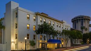 a white building on a city street with a building at Motel 6-San Diego, CA - Downtown in San Diego