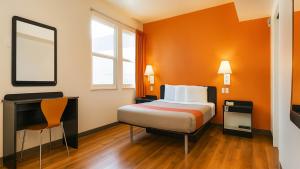 a hotel room with a bed and a desk at Motel 6-San Diego, CA - Downtown in San Diego