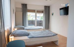 Ένα ή περισσότερα κρεβάτια σε δωμάτιο στο BEGE APARTMENTS WorkConnect