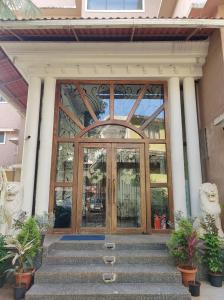 an entrance to a building with a glass door at Ora Stays by Q 23 - Near to Fortune Select Candolim in Candolim