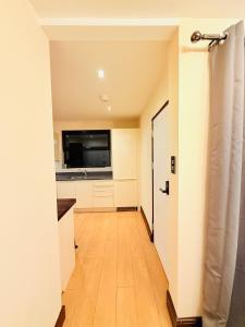 a hallway leading to a kitchen with a door at Tower Bridge Apartments in London +42 photos