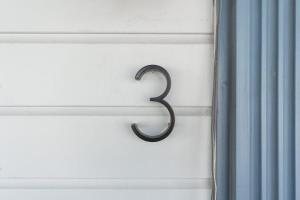 a metal number on a window with a curtain at The Cowboy Social Unit 3 in Williams