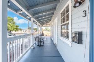a porch of a house with a table and chairs at The Cowboy Social Unit 3 in Williams