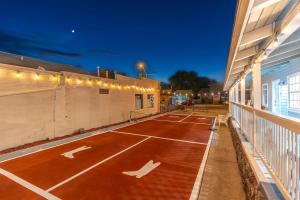 a tennis court in front of a building at night at The Cowboy Social Unit 4 in Williams