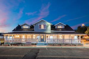 a large house with a front porch at night at The Cowboy Social Unit 4 in Williams