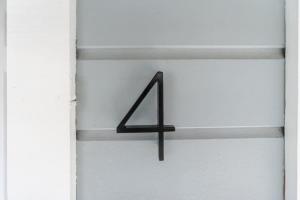 a black arrow sign hanging on a white wall at The Cowboy Social Unit 4 in Williams