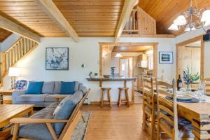 a living room and kitchen with wooden ceilings and a table at Mtn-View Deck Stunning Fraser Home By Ski Shuttle in Maryvale