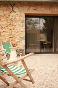 a couple of lawn chairs sitting in front of a building at Gîte 'Le 31' in Coulaines