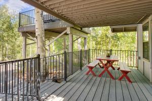 a wooden deck with a picnic table and a balcony at Mtn-View Deck Stunning Fraser Home By Ski Shuttle in Maryvale