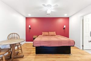 a bedroom with a bed and a red wall at The Cowboy Social Unit 5 in Williams