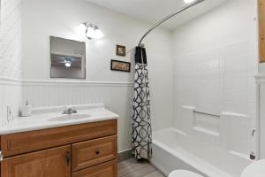 a bathroom with a sink and a tub and a shower at The Cowboy Social Unit 5 in Williams