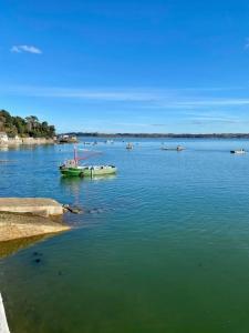 a boat in a large body of water at BB les pieds dans L'eau CARANTEC in Carantec +6 photos