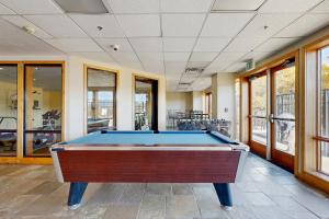 a pool table in a large room with windows at The Lodge at Stillwater #2012 in Heber City