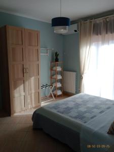 a bedroom with a bed and a large window at The Way of the Tower in Isola Sacra