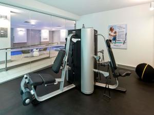 a room with a gym with two tread machines at Novotel Melbourne On Collins in Melbourne
