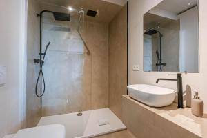 a bathroom with a sink and a shower at Huswell - Modern studio with magnificent seaview in Koksijde +15 photos