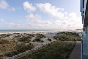 a view of the beach from the balcony of a building at Huswell - Modern studio with magnificent seaview in Koksijde
