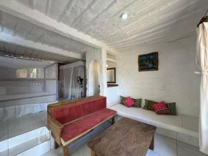 a living room with a red couch and a table at Shimoni Reef Lodge in Shimoni