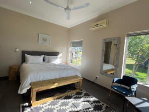 a bedroom with a bed and a chair and a window at La Vita Farm Stay in Wellington