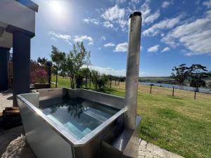 a hot tub on the side of a house at La Vita Farm Stay in Wellington +2 photos