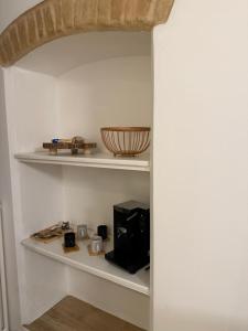 a shelf in a room with some items on it at Le Casette in Macerata