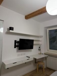 a living room with a tv on a wall at Le Casette in Macerata