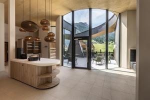 a kitchen with a large window with a mountain view at Neueröffnung ELVA PREMIUM APARTMENT HOTEL inklusive Sommerpass STUBAI SUPER CARD in Neustift im Stubaital