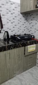 a kitchen counter with a stove top on top of it at Ekebute BnB in Mombasa
