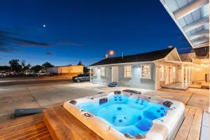 a hot tub on a patio in front of a house at The Cowboy Social Unit 10 in Williams