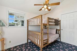 a bedroom with a bunk bed and a ceiling fan at The Cowboy Social Unit 10 in Williams +20 photos