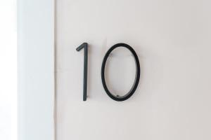 a mirror hanging on a wall with the number one at The Cowboy Social Unit 10 in Williams