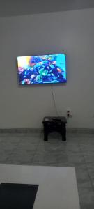 a flat screen tv hanging on a white wall at Ekebute BnB in Mombasa