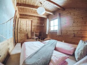 a room with two beds in a wooden cabin at Cozy holiday apartment close to the slopes in Kleinarl +50 photos