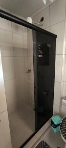 a shower with a glass door in a bathroom at Casa com garagem no coração de Arraial! in Arraial do Cabo
