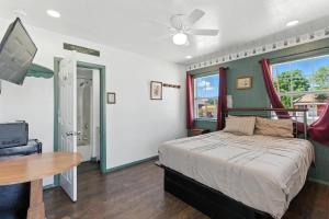 a bedroom with a bed and a table and a tv at The Cowboy Social Unit 14 in Williams +16 photos