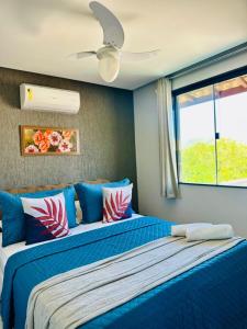 two beds in a bedroom with blue walls at Pousada Amaral Búzios in Búzios +69 photos
