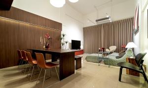 a living room with a dining room table and chairs at Roni House Thonglor in Bangkok