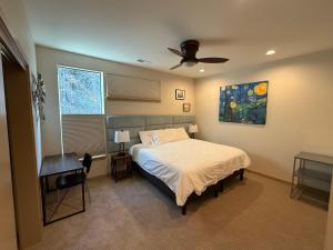 a bedroom with a bed and a ceiling fan at Mountain House in Mount Hood
