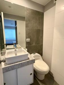a bathroom with a toilet and a sink at Departamento Osma in Lima