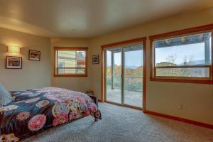 a bedroom with a bed and a large window at Three Rivers 30 day minimum in Hood River