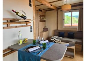 a room with a table with a bottle of wine at Tiny d'Monts in Brullioles