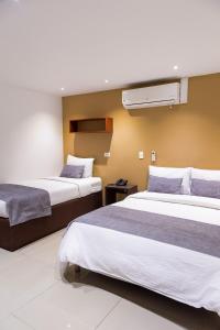 a hotel room with two beds at Hotel Laureles Loft in Medellín +40 photos