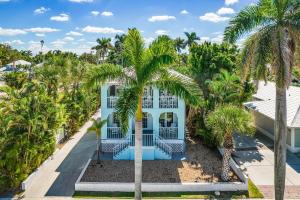 an aerial view of a blue house with palm trees at Place your bet on a WINNING Vacation Retreat - Peace River Pair-A-Dice - Roelens in Punta Gorda