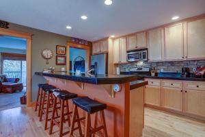 a kitchen with a large island with bar stools at Wanderlust in Hood River +32 photos